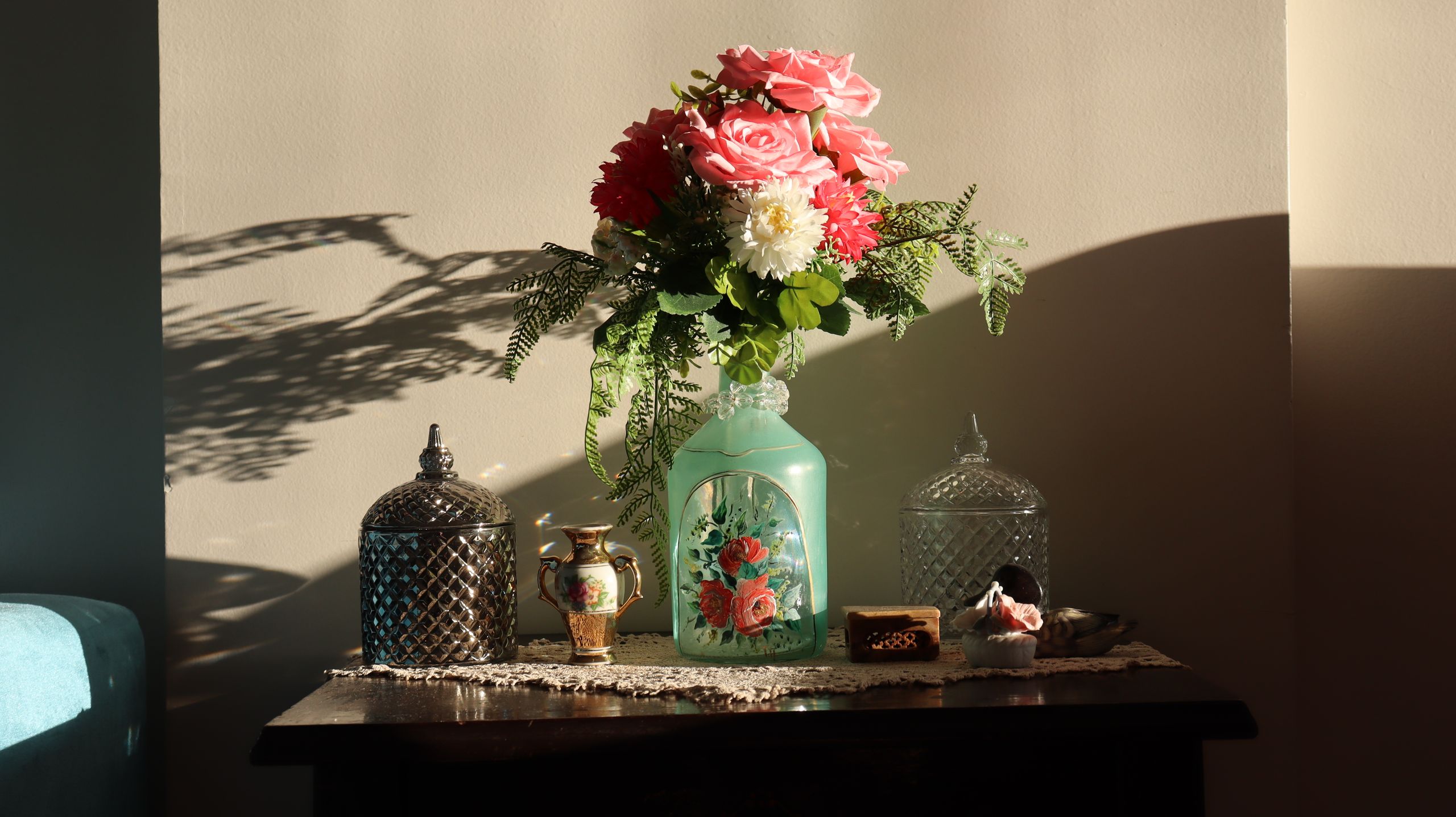 Vase with ferns and bottles