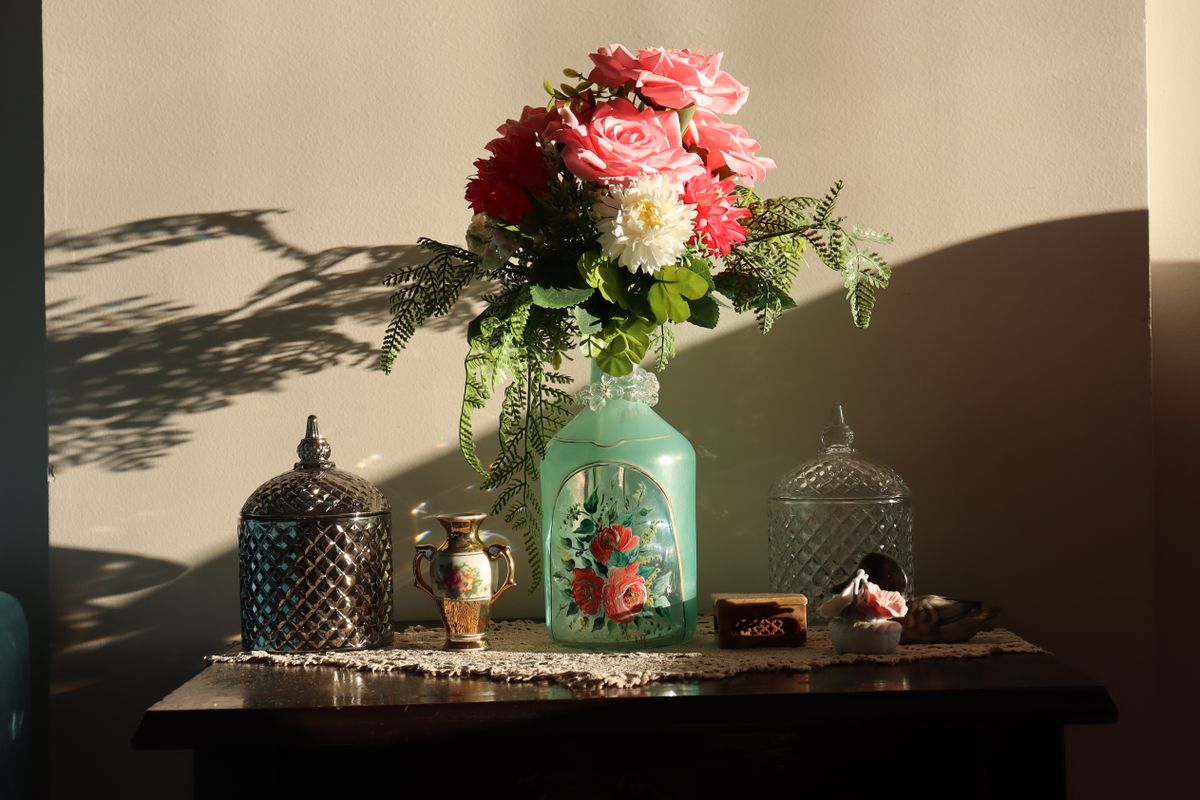 Vase with ferns and bottles
