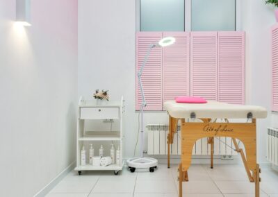 Interior of modern beauty salon with assorted skin products and couch for clients placed against window covered with shutters